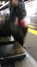 Blurred motion of man walking at railroad station