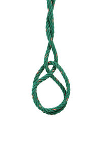 Close-up of rope tied over white background
