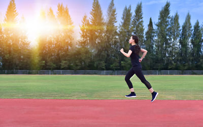 Full length of man running on field