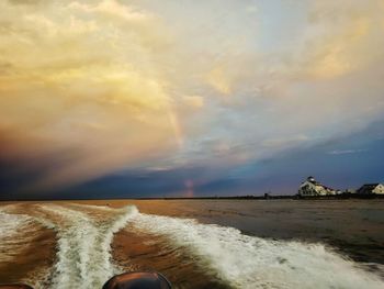 Scenic view of beach against sky during sunset