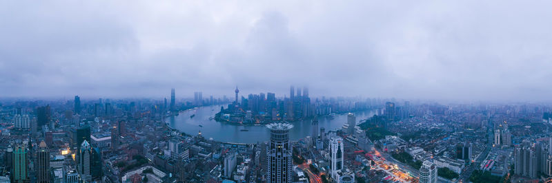 High angle view of city against cloudy sky