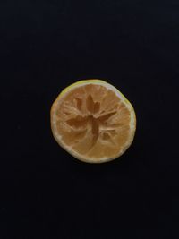 Close-up of lemon slice over black background