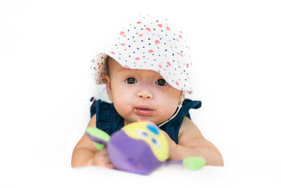 Portrait of baby girl against white background