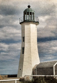 Low angle view of lighthouse against cloudy sky