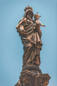 Low angle view of statue against clear blue sky