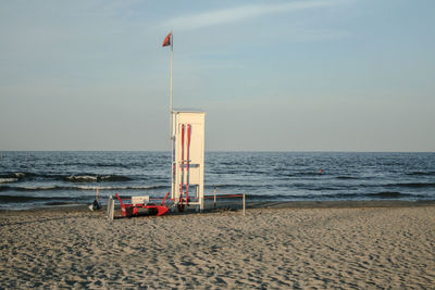 Lifeguard hut on beach against sky