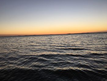 Scenic view of sea against clear sky during sunset