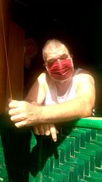 Portrait of man holding lit candles