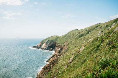 Scenic view of sea and mountains against sky