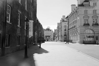 Empty alley amidst buildings in city