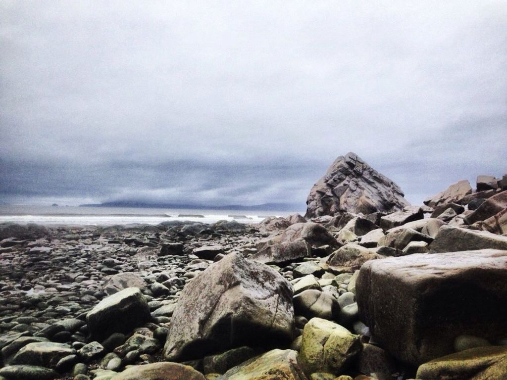 water, sea, sky, rock - object, scenics, horizon over water, tranquility, beach, tranquil scene, nature, beauty in nature, shore, cloud - sky, day, outdoors, idyllic, stone - object, rock formation, remote, non-urban scene