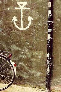 Close-up of bicycle by water