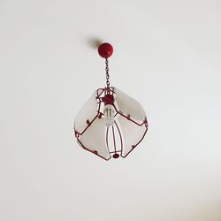 Modern lamp hanging from white ceiling