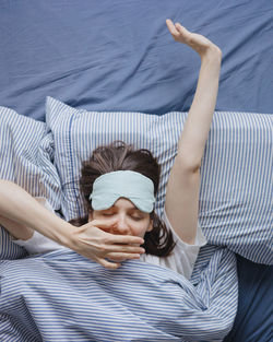 Portrait of woman lying on bed at home