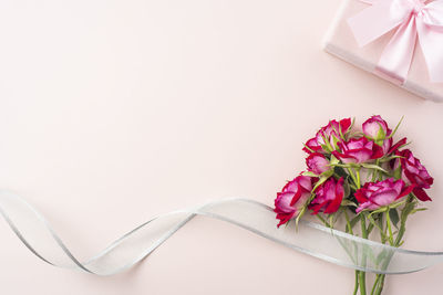 Close-up of pink rose on table