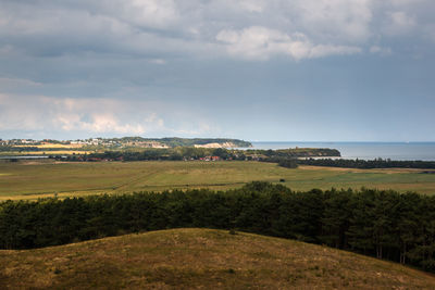 Scenic view of agricultural field against sky