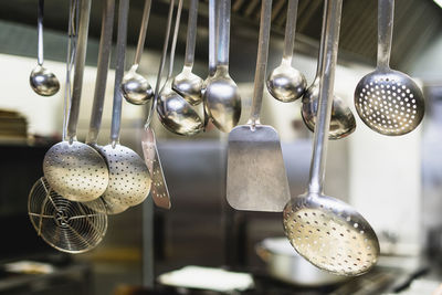 Kitchen utensils hanging in kitchen at home