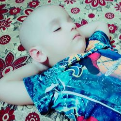 High angle view of baby sleeping on bed