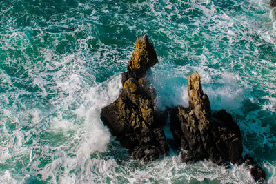 High angle view of rocks in sea