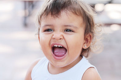 Close-up of cute little girl screaming