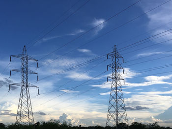Low angle view of electricity pylon against the sky