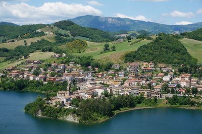 Scenic view of townscape and mountains against sky