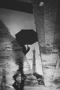 High angle view of man holding umbrella on street