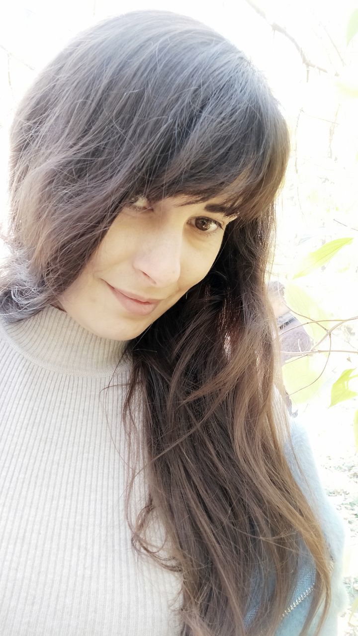 CLOSE-UP PORTRAIT OF A YOUNG WOMAN WITH HAIR