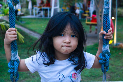 Portrait of cute girl playing in public park