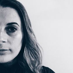 Close-up portrait of woman against white background