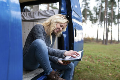 Woman sitting on seat in park
