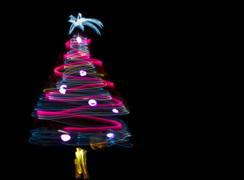 Close-up of illuminated christmas tree at night