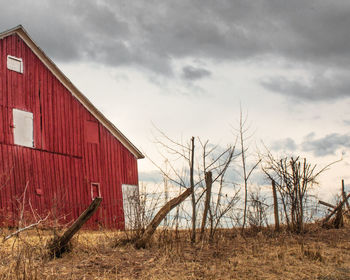 Barn on field against sky