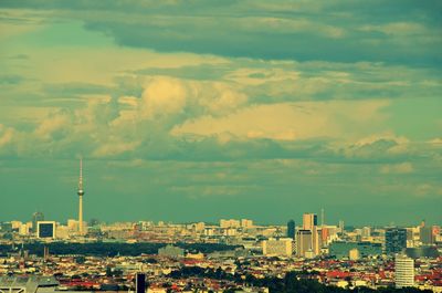 Cityscape against cloudy sky