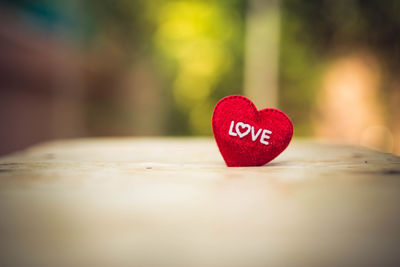 Close-up of heart shape on red table