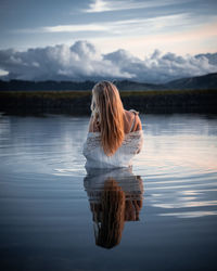 Rear view of woman looking at lake