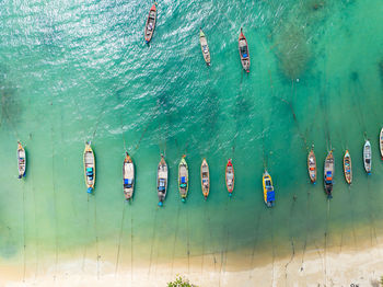 Aerial view top down longtail fishing boats at the sea in phuket thailand