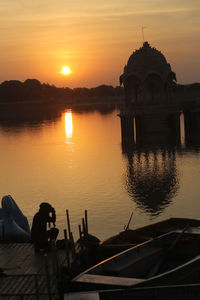 Scenic view of lake against sky during sunset