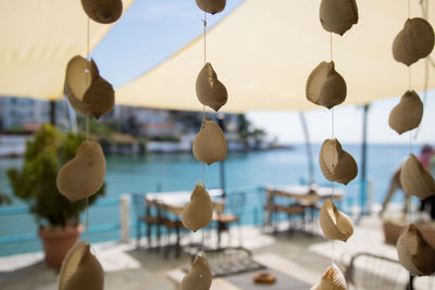 Close-up of multi colored umbrellas hanging over water