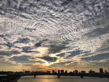 Scenic view of silhouette buildings against sky during sunset