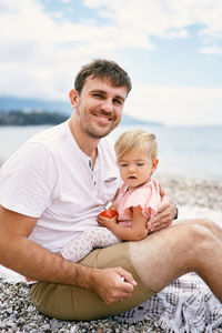 Father with baby on beach