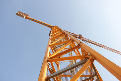 Low angle view of crane against clear sky