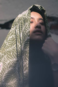 Close-up of young woman with shawl