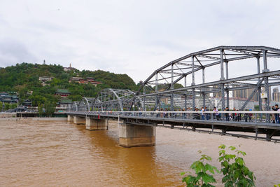 Bridge over river against sky