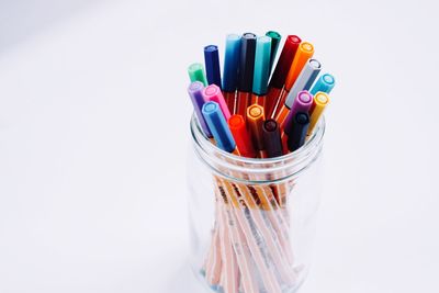 Close-up of multi colored pencils against white background