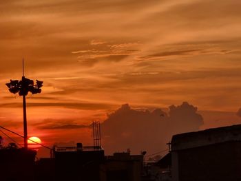 Low angle view of silhouette buildings against sky during sunset