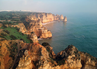 High angle view of rocks in sea against sky