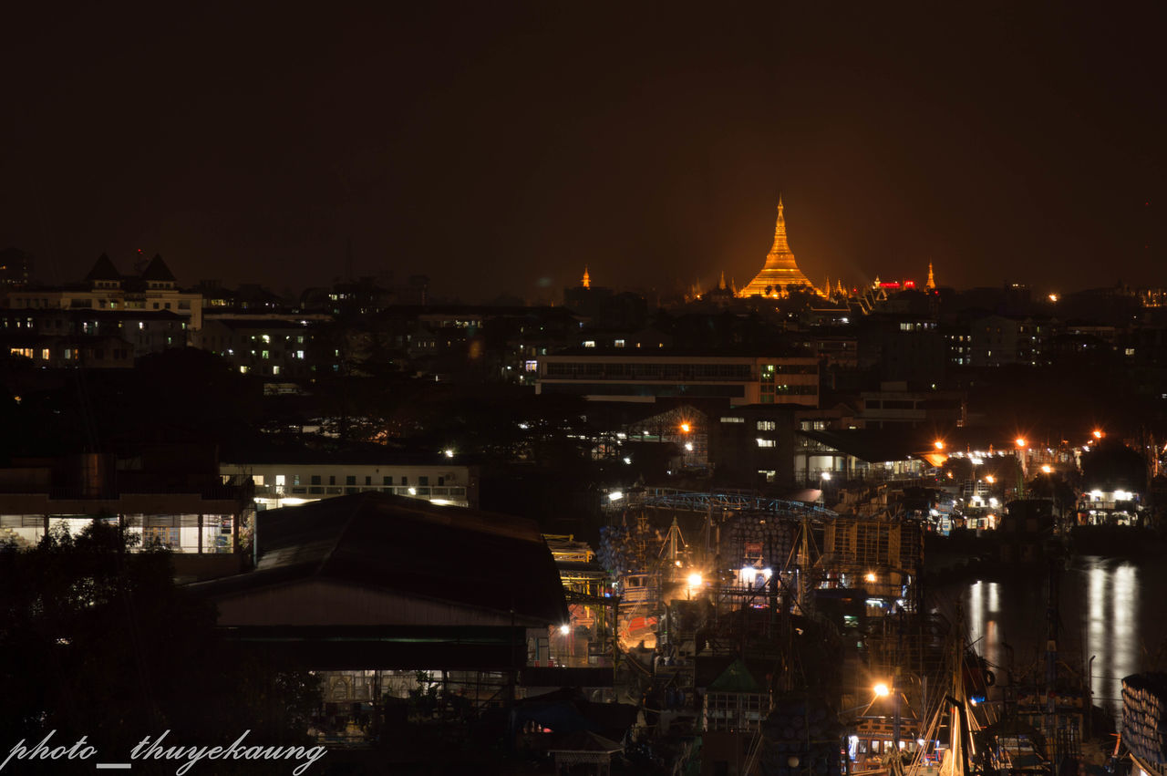 illuminated, night, building exterior, architecture, built structure, city, cityscape, high angle view, crowded, residential building, dark, residential district, copy space, clear sky, city life, sky, residential structure, outdoors, no people, lighting equipment