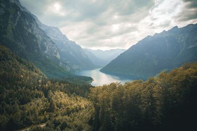 Scenic view of lake amidst mountains against sky