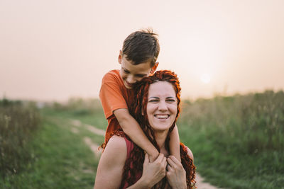 Happy mother having fun with her son outdoor. family and love concept.